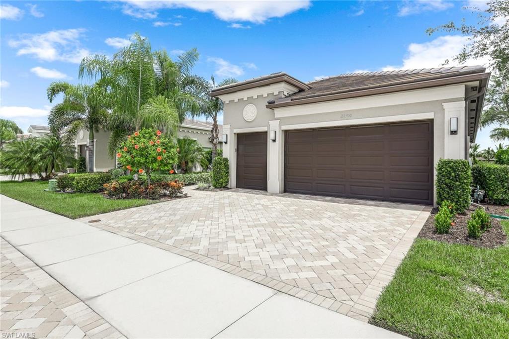 a front view of a house with a yard and garage