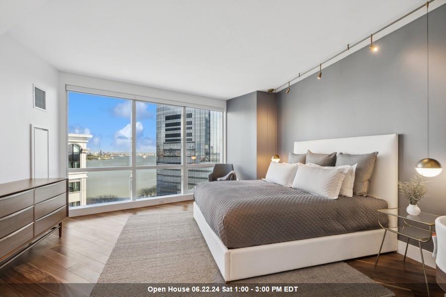 a bedroom with a large bed and a view of balcony