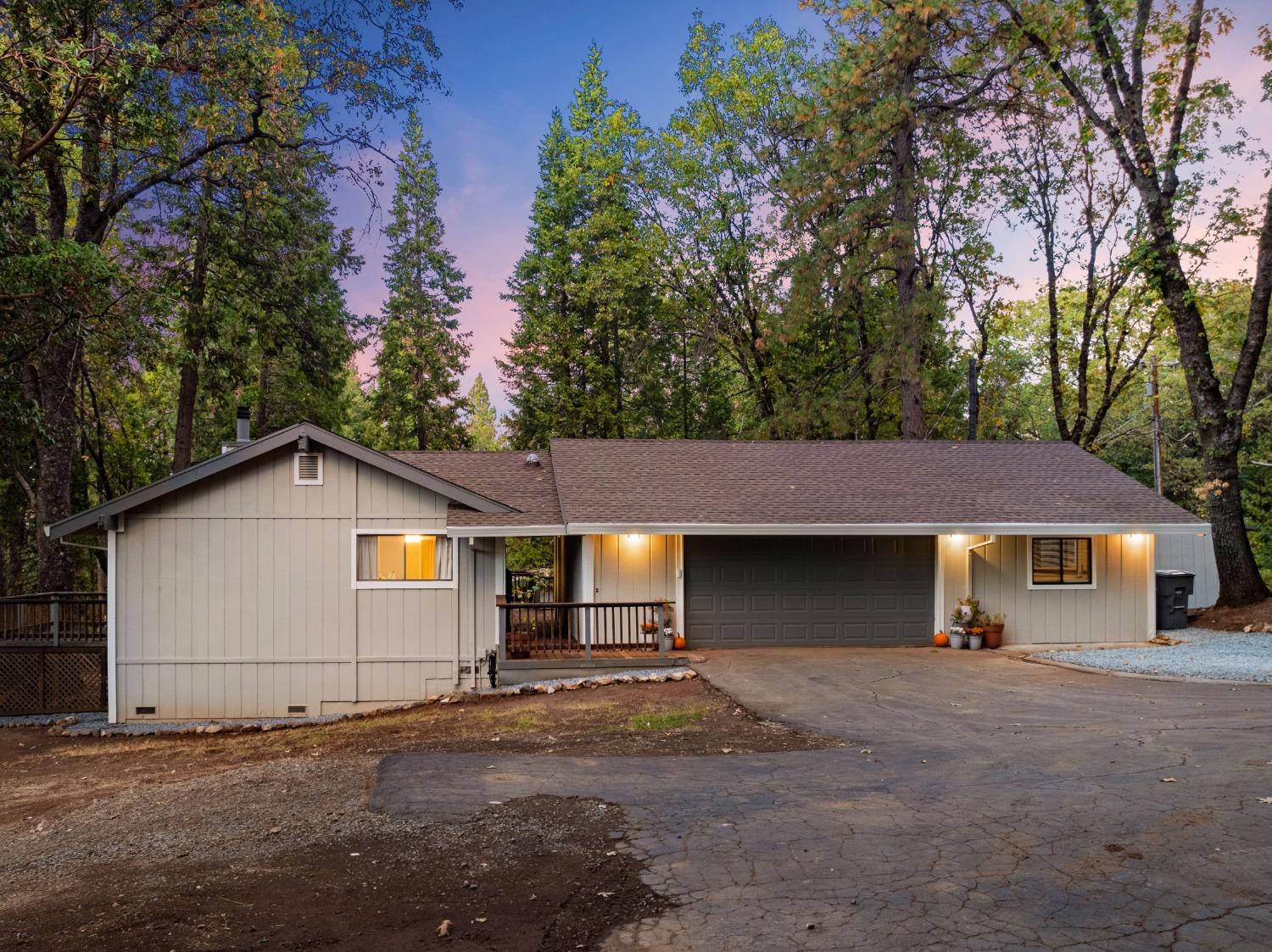 a view of a house with a yard and tree