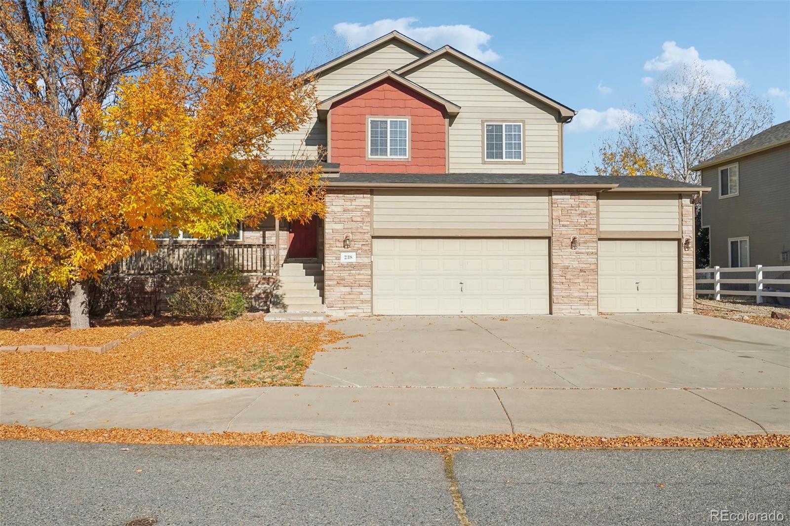 a view of a house with a yard and garage