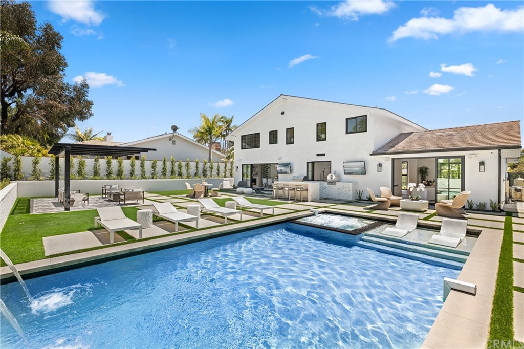 a view of swimming pool with outdoor seating and deck