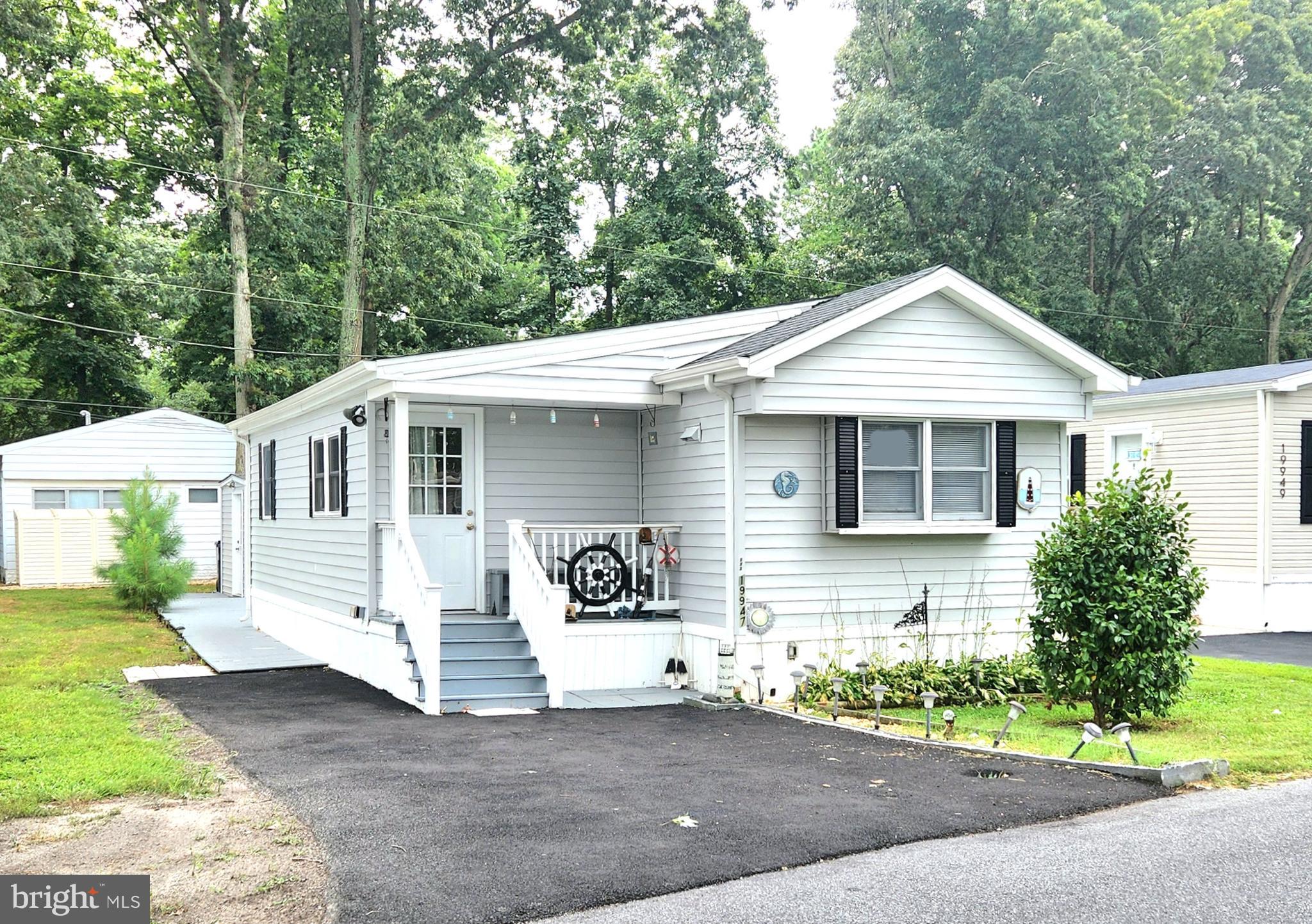 a front view of a house with a garden and plants