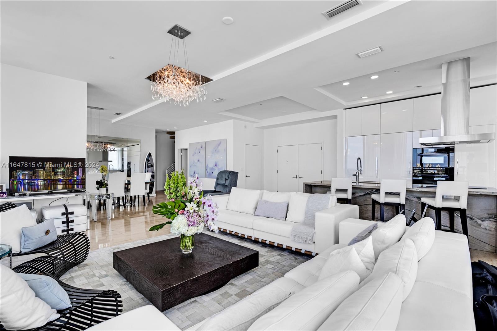 a living room with furniture a dining table and a fireplace