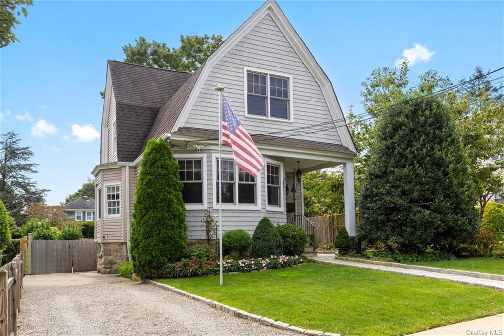 a view of a house with a yard and potted plants