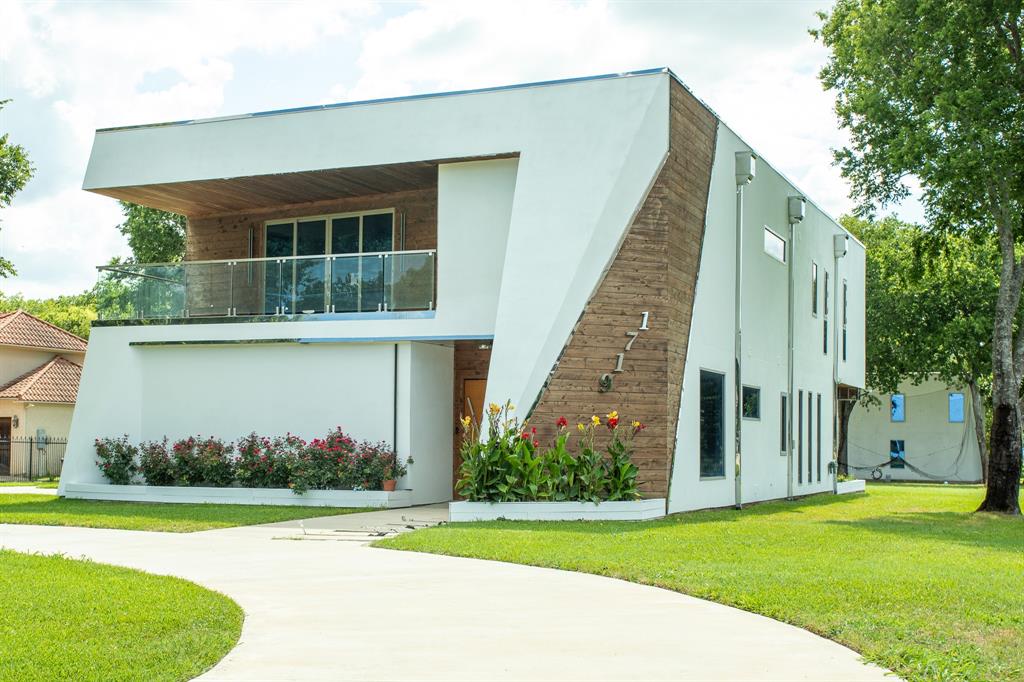 a front view of a house with a yard and trees