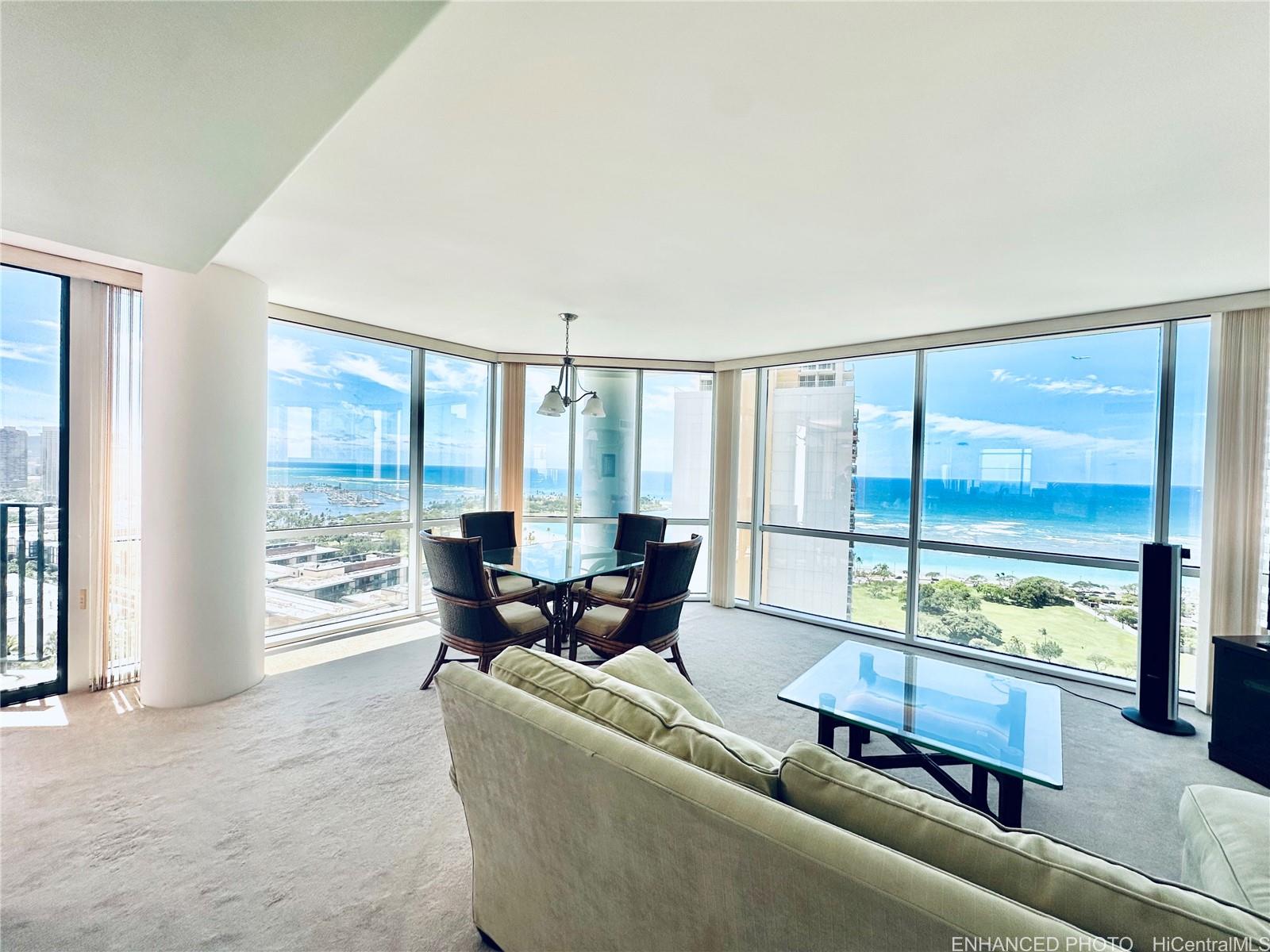 a living room with furniture and large windows