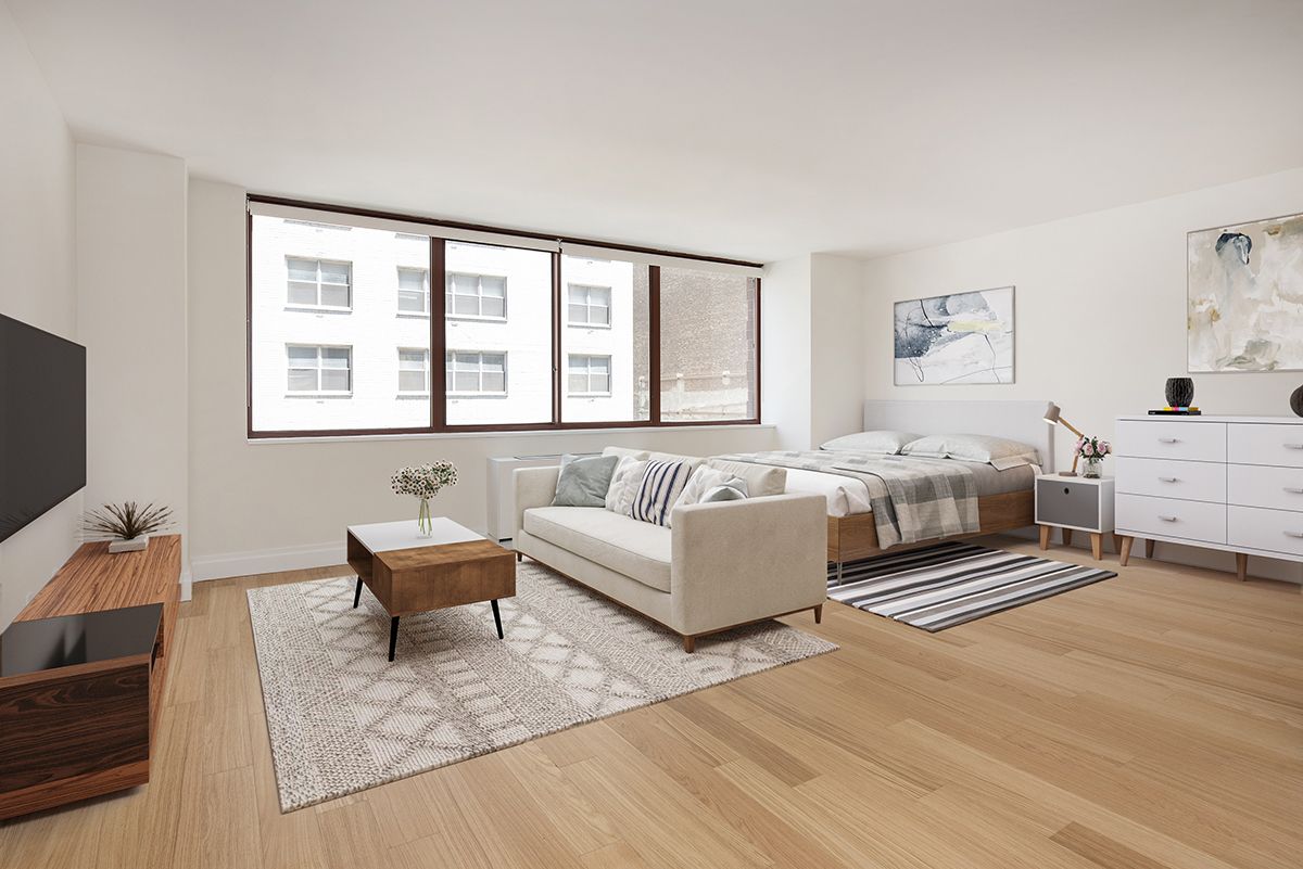 a spacious bedroom with a bed couch and a window