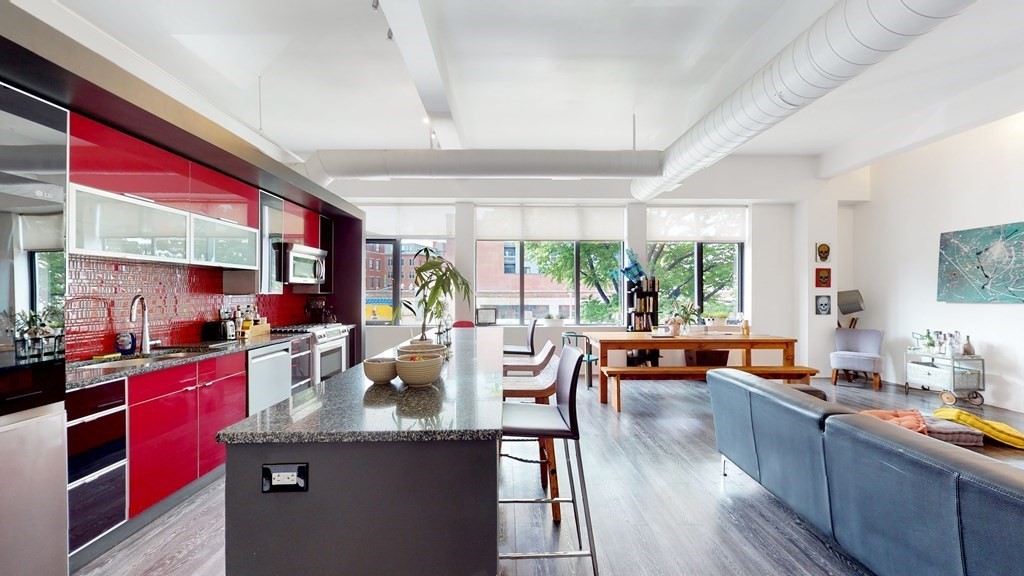 a kitchen with stainless steel appliances granite countertop sink stove top oven and cabinets