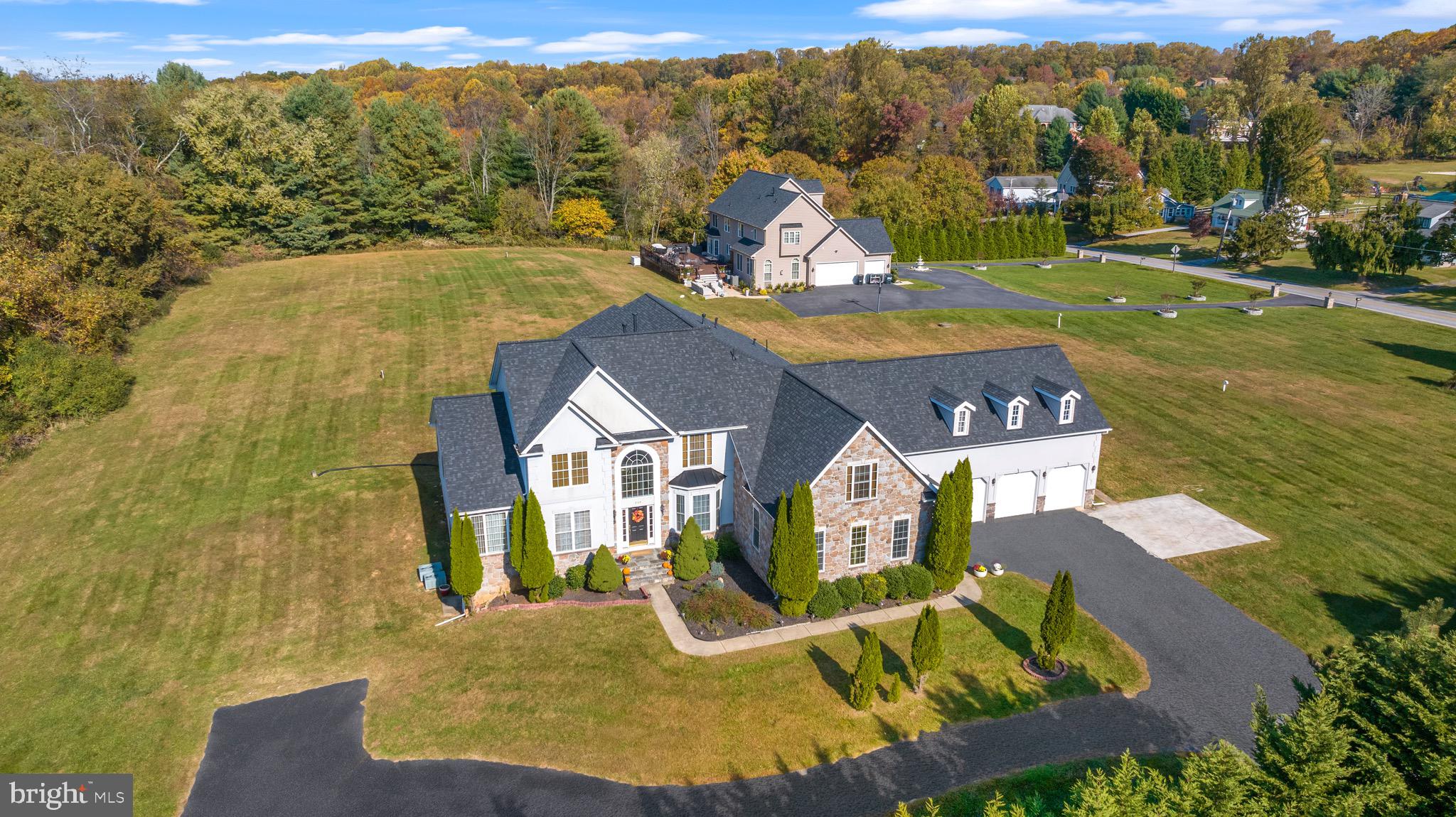 an aerial view of a house with a swimming pool