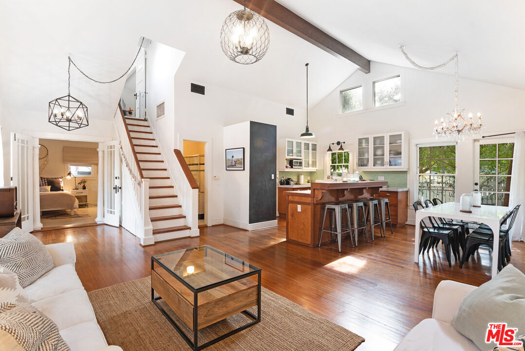 a living room with lots of furniture and a chandelier