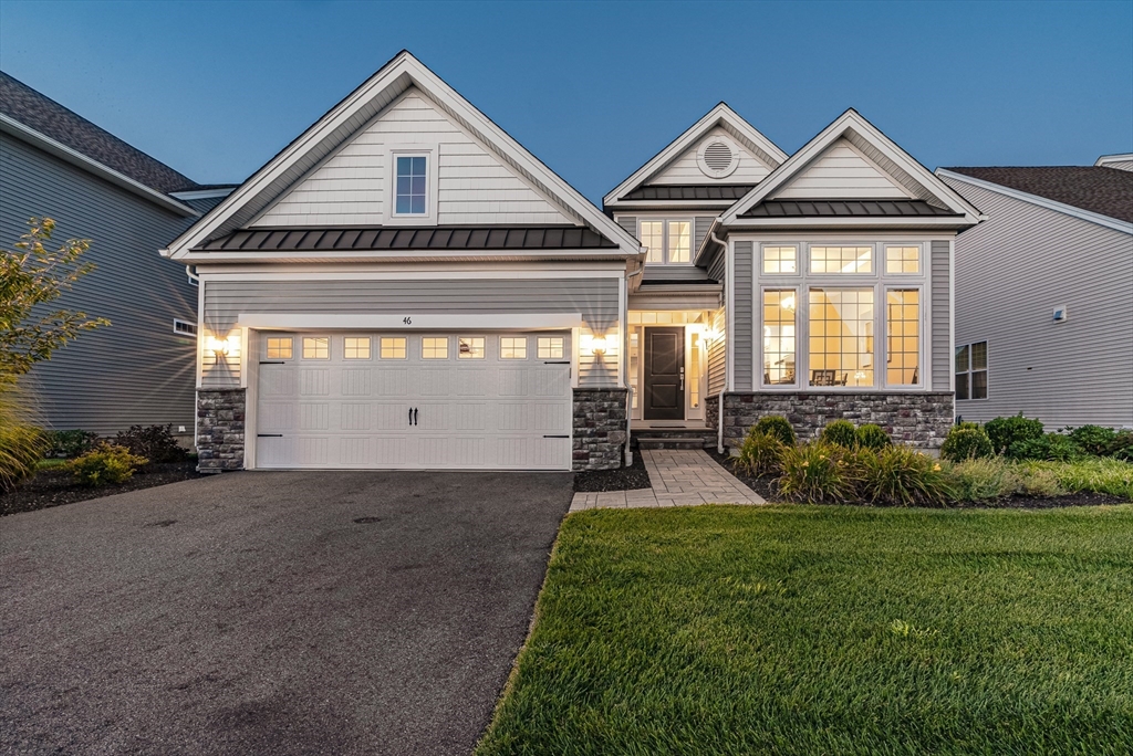 a front view of a house with a yard and garage