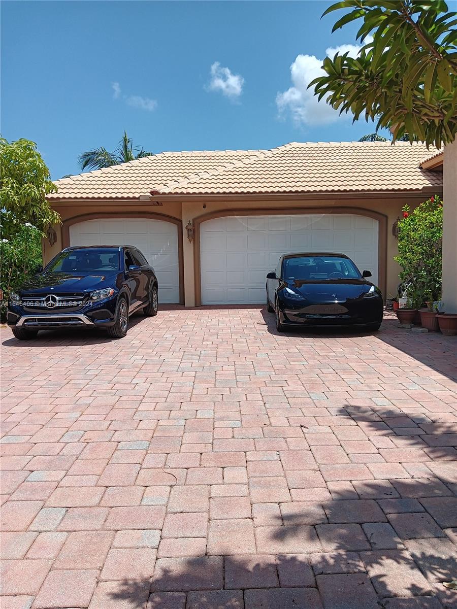 a view of garage with a car parked in it