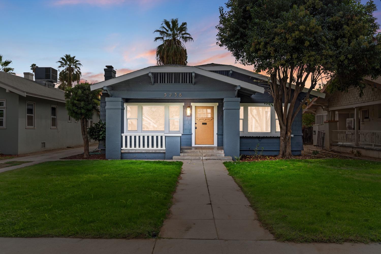 a view of a front of a house with a yard