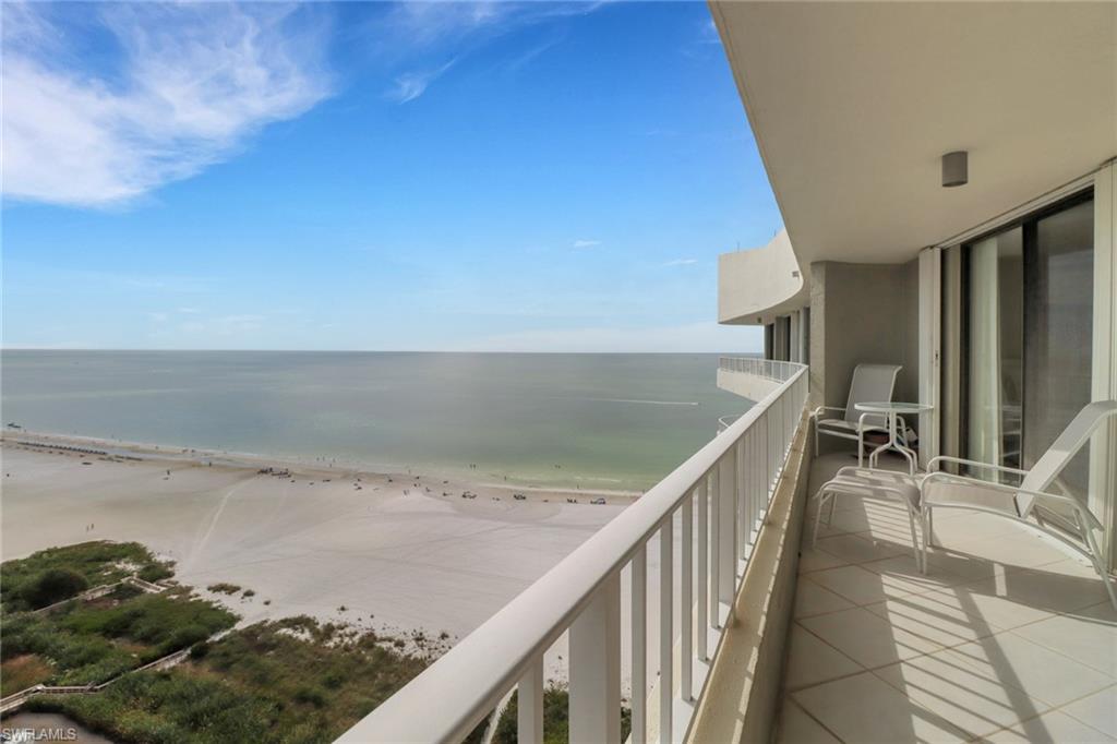 Balcony with a water view and a beach view