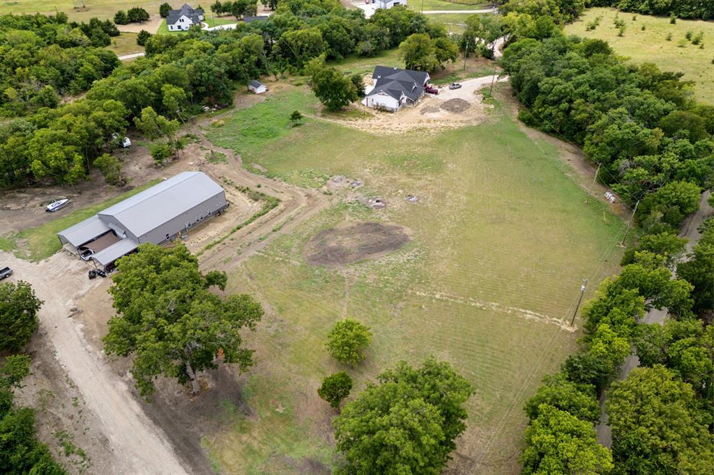 an aerial view of a residential houses with outdoor space