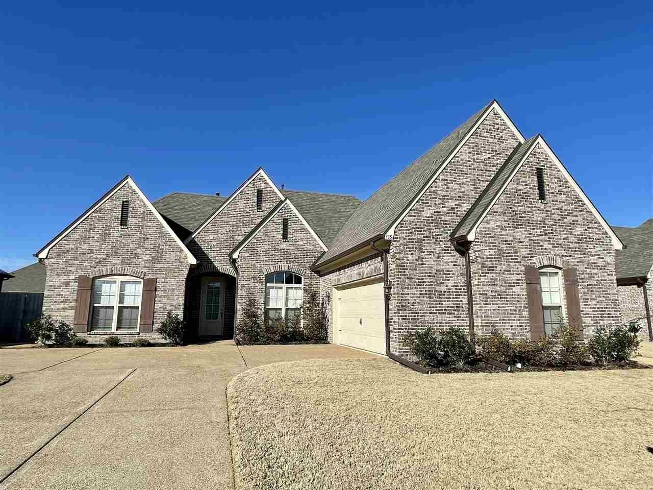 a front view of a house with yard