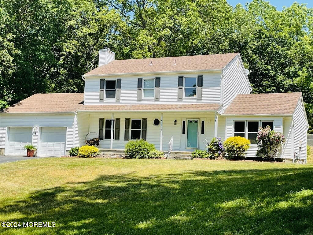 a front view of a house with swimming pool and porch