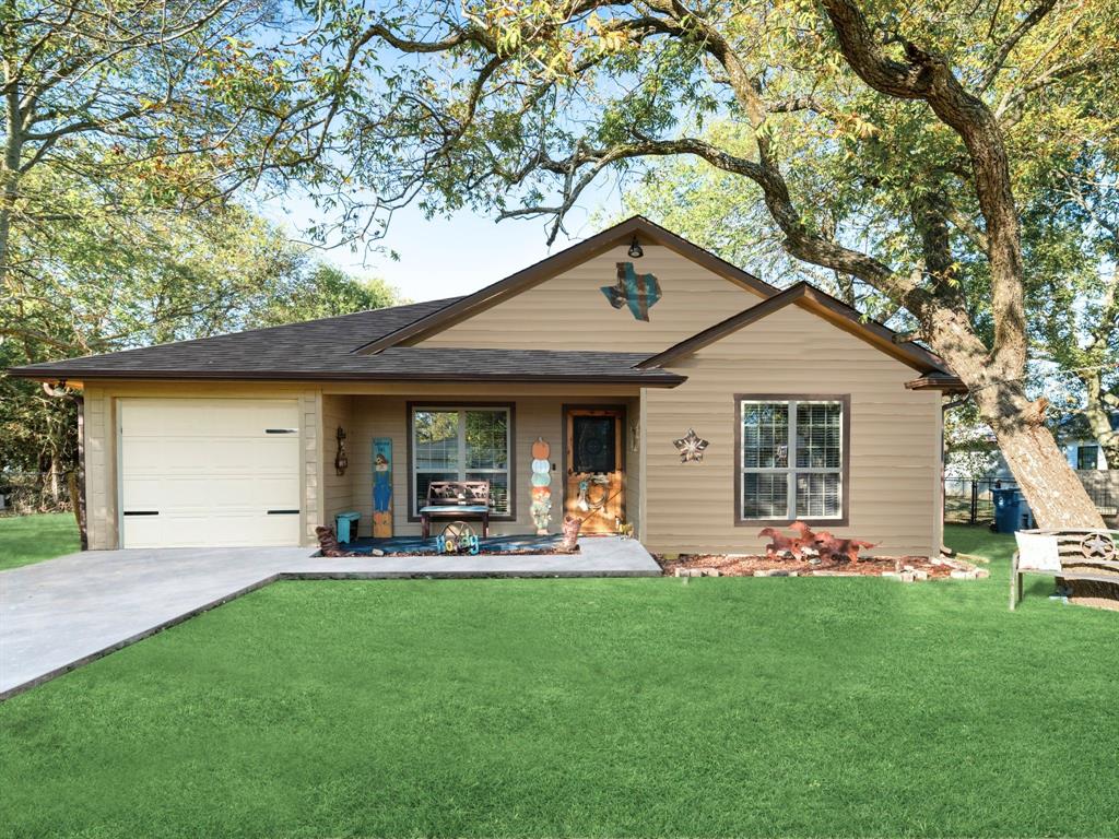 a front view of house with yard and outdoor seating