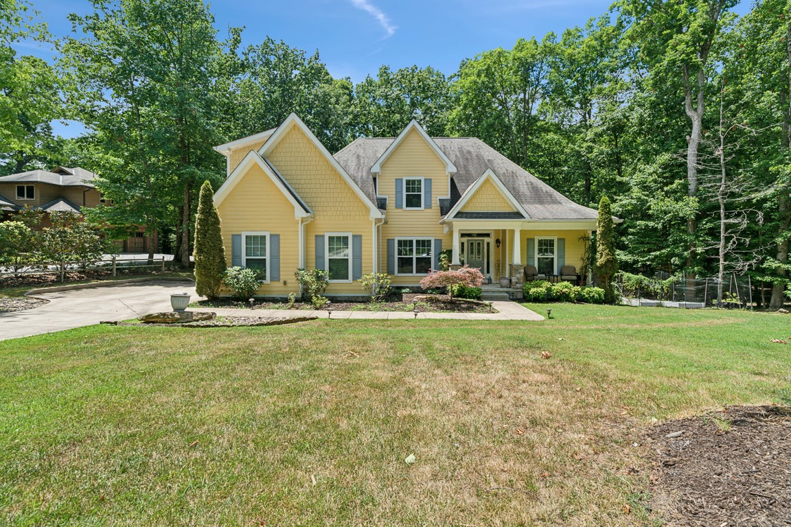 a view of a house with backyard and sitting area