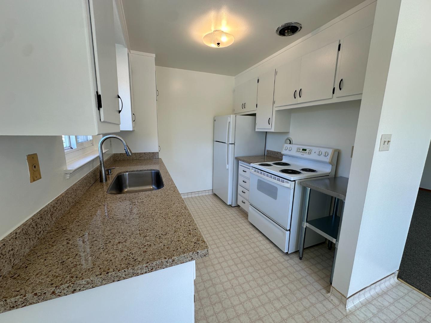 a kitchen that has a sink and a stove