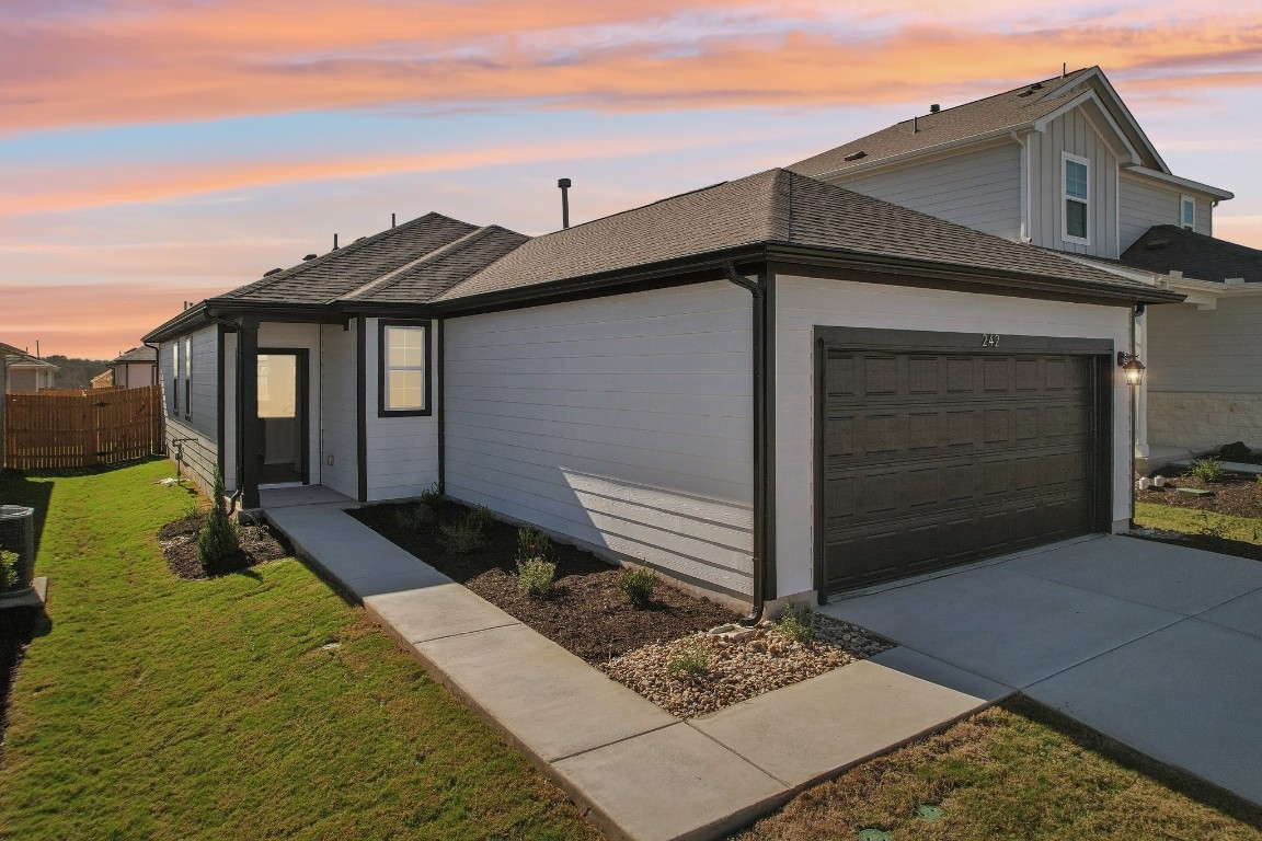 a front view of a house with garden