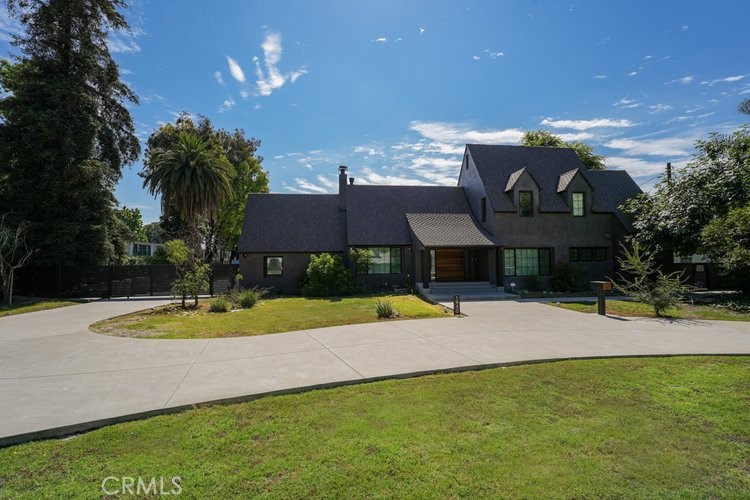 a view of a house with pool and a yard