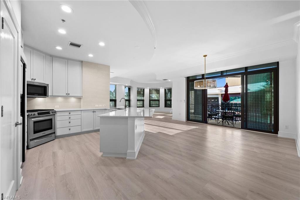 a kitchen with stove and cabinets