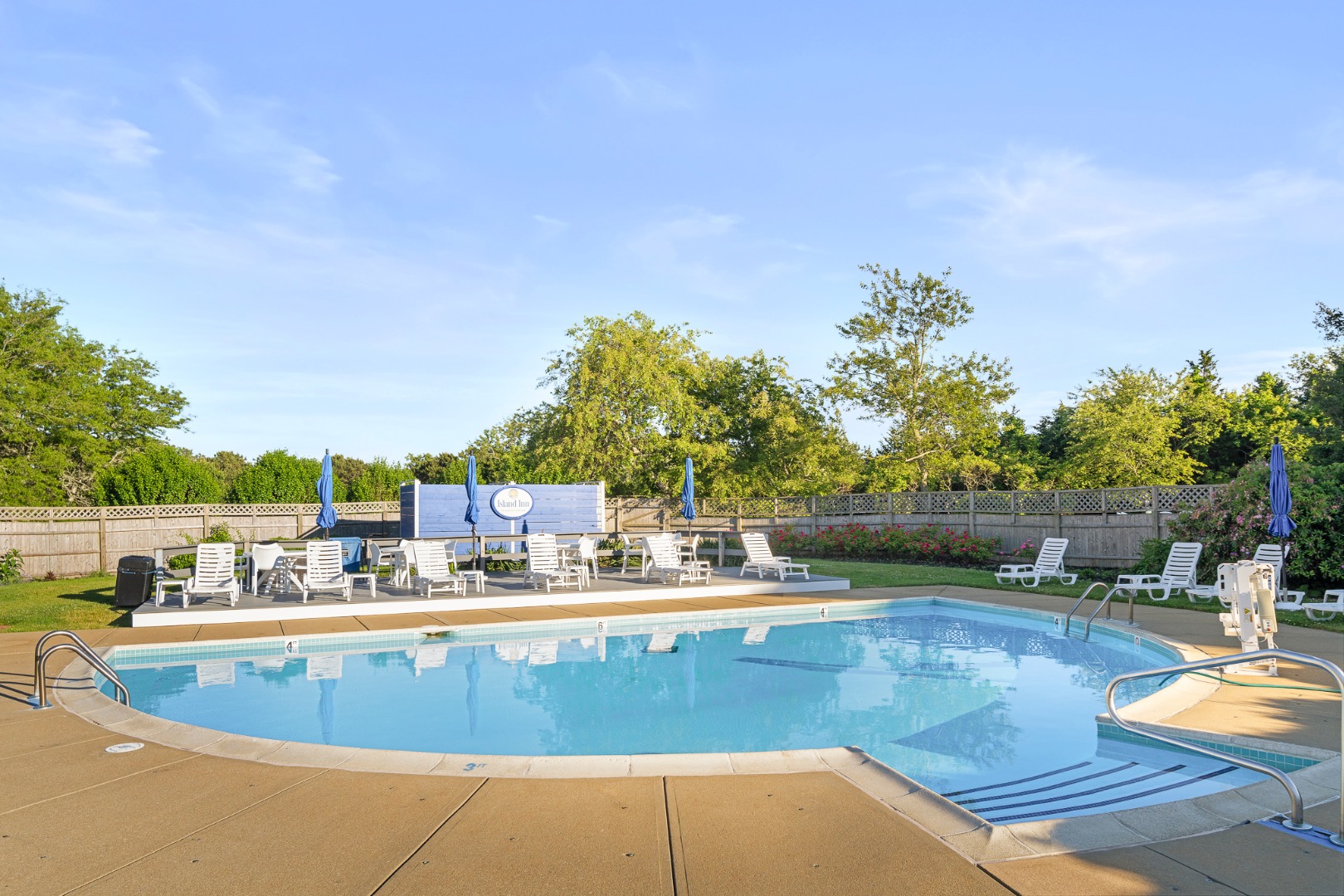 a view of a swimming pool with an outdoor seating and a garden