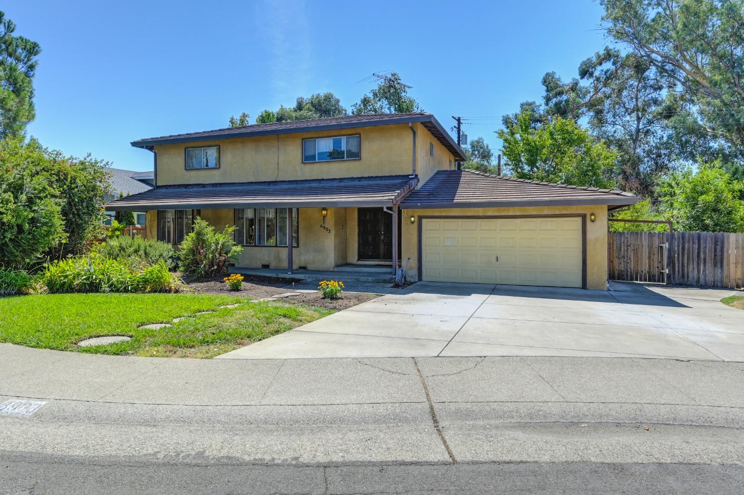 a front view of a house with a yard and a garage