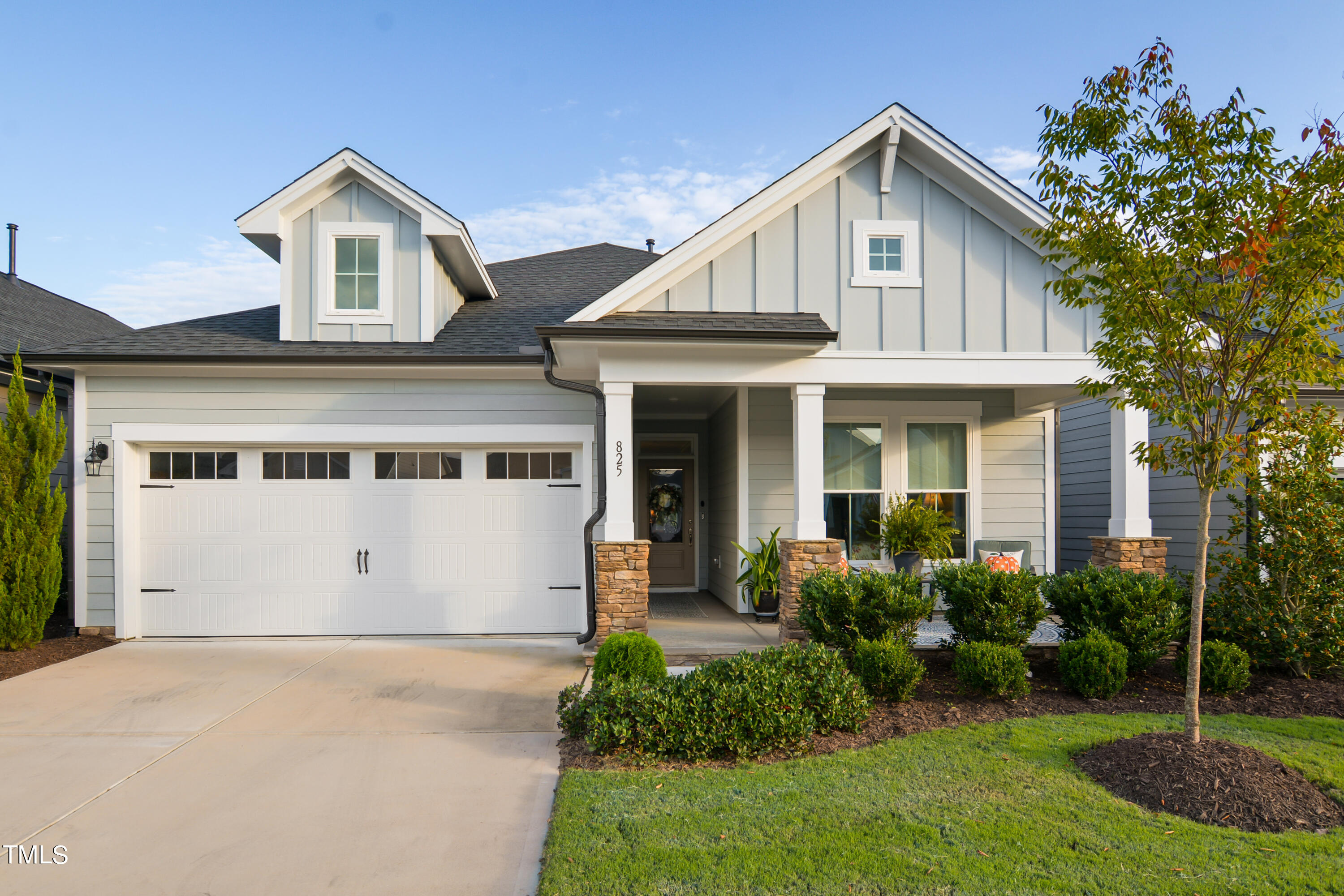 a front view of a house with a garden