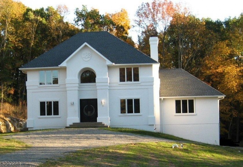 a view of house with yard and swimming pool