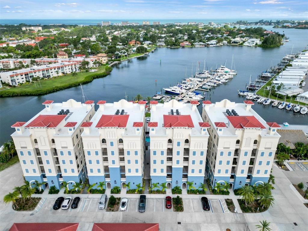 an aerial view of residential houses with outdoor space and lake view