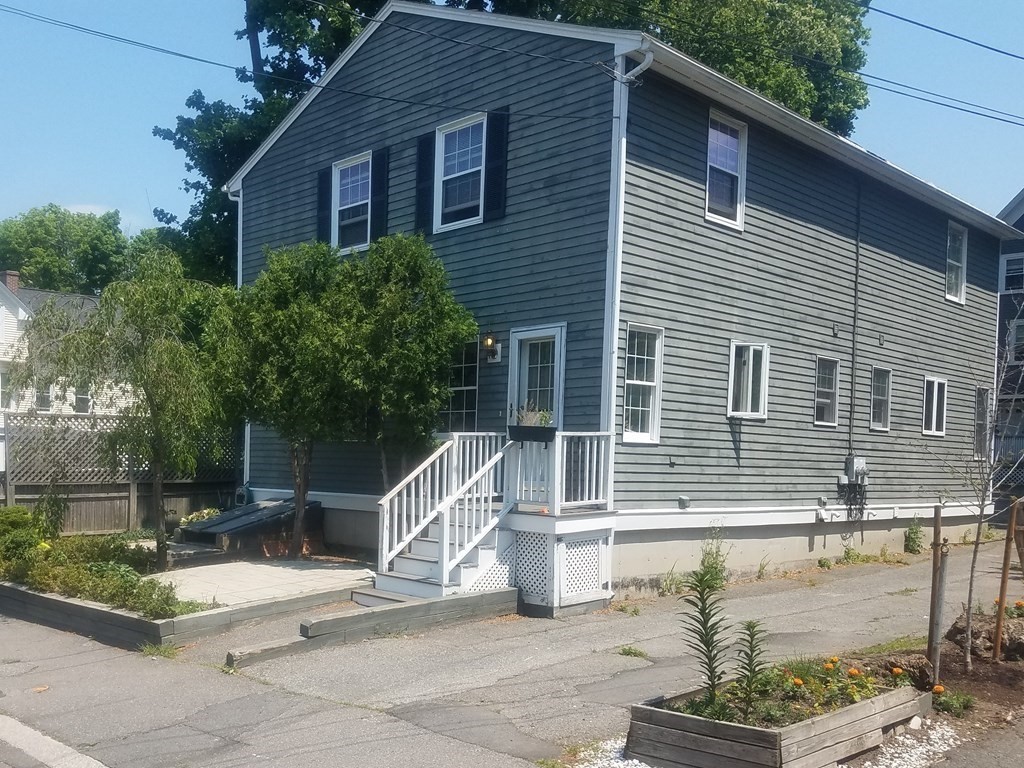 a view of a house with a chairs in patio