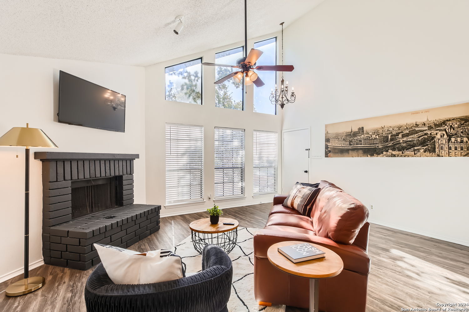 a living room with furniture a fireplace and a flat screen tv