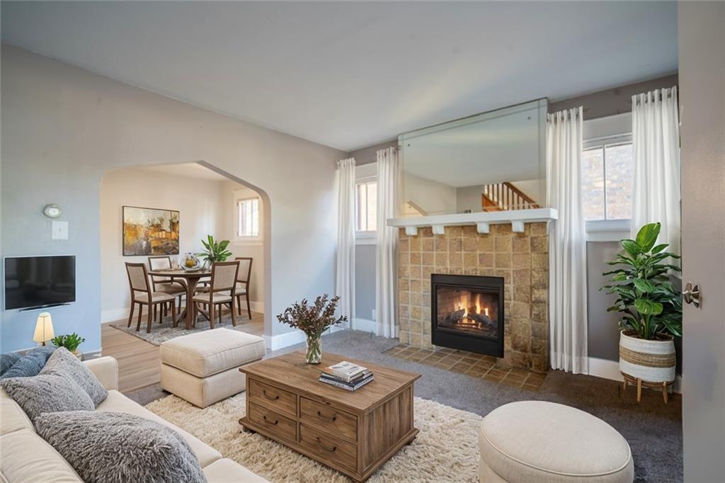 a living room with furniture and a fireplace