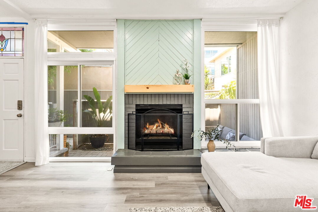 a living room with a fireplace and a large window