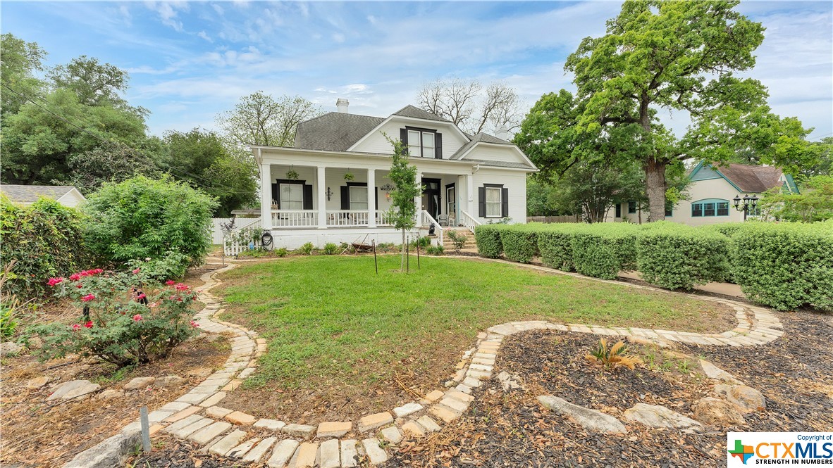 a front view of house with yard and green space