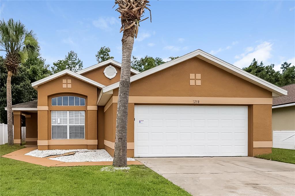 a front view of a house with a yard and garage