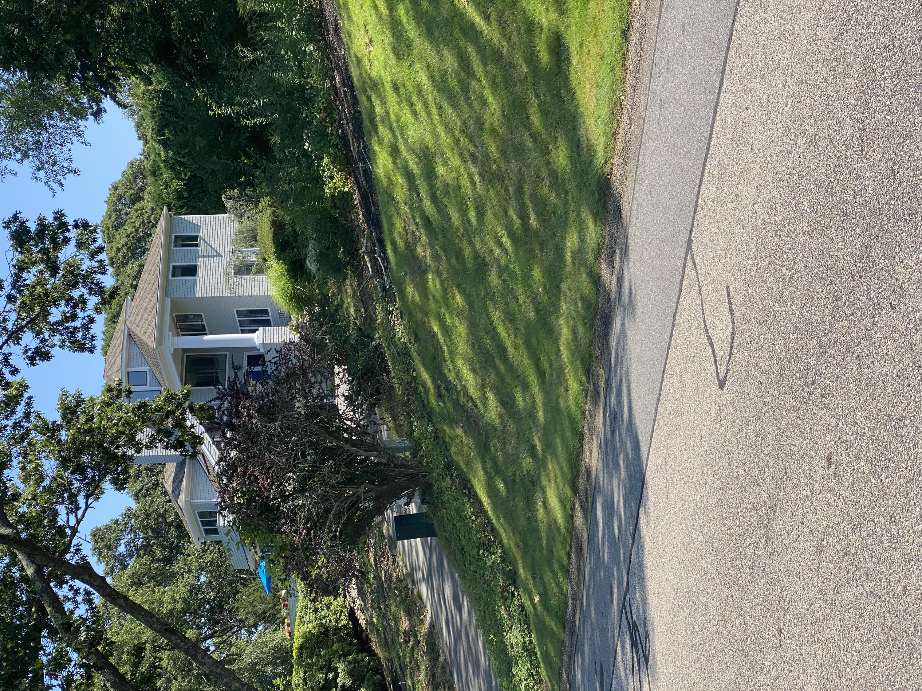 a front view of house with yard and green space