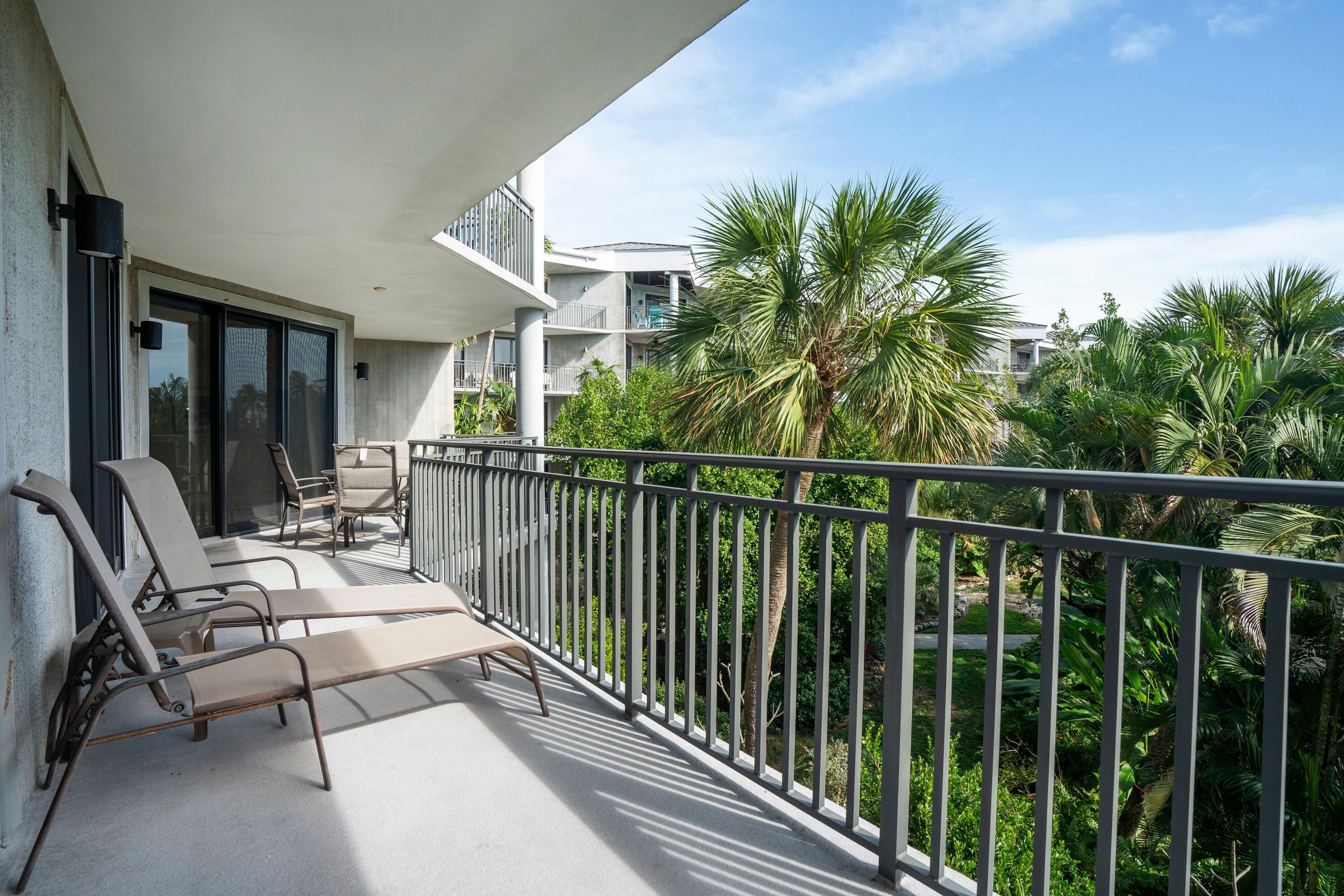 a view of a balcony with chairs