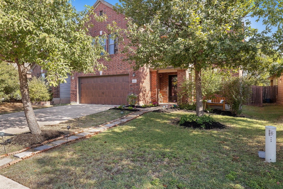 a backyard of a house with plants and trees