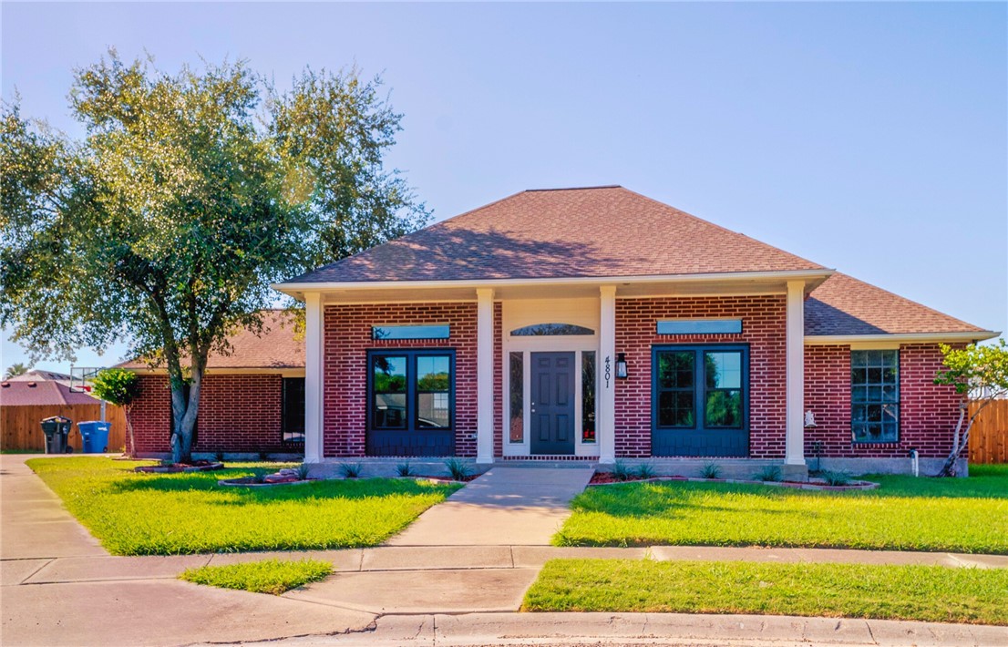 a view of a house with a swimming pool and a yard