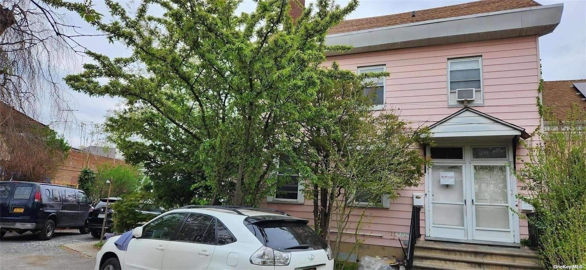 a front view of a house with a garden