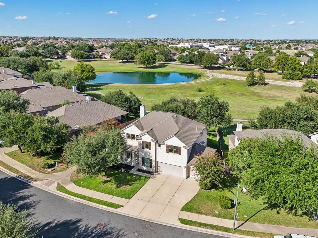 an aerial view of a house with garden space and street view