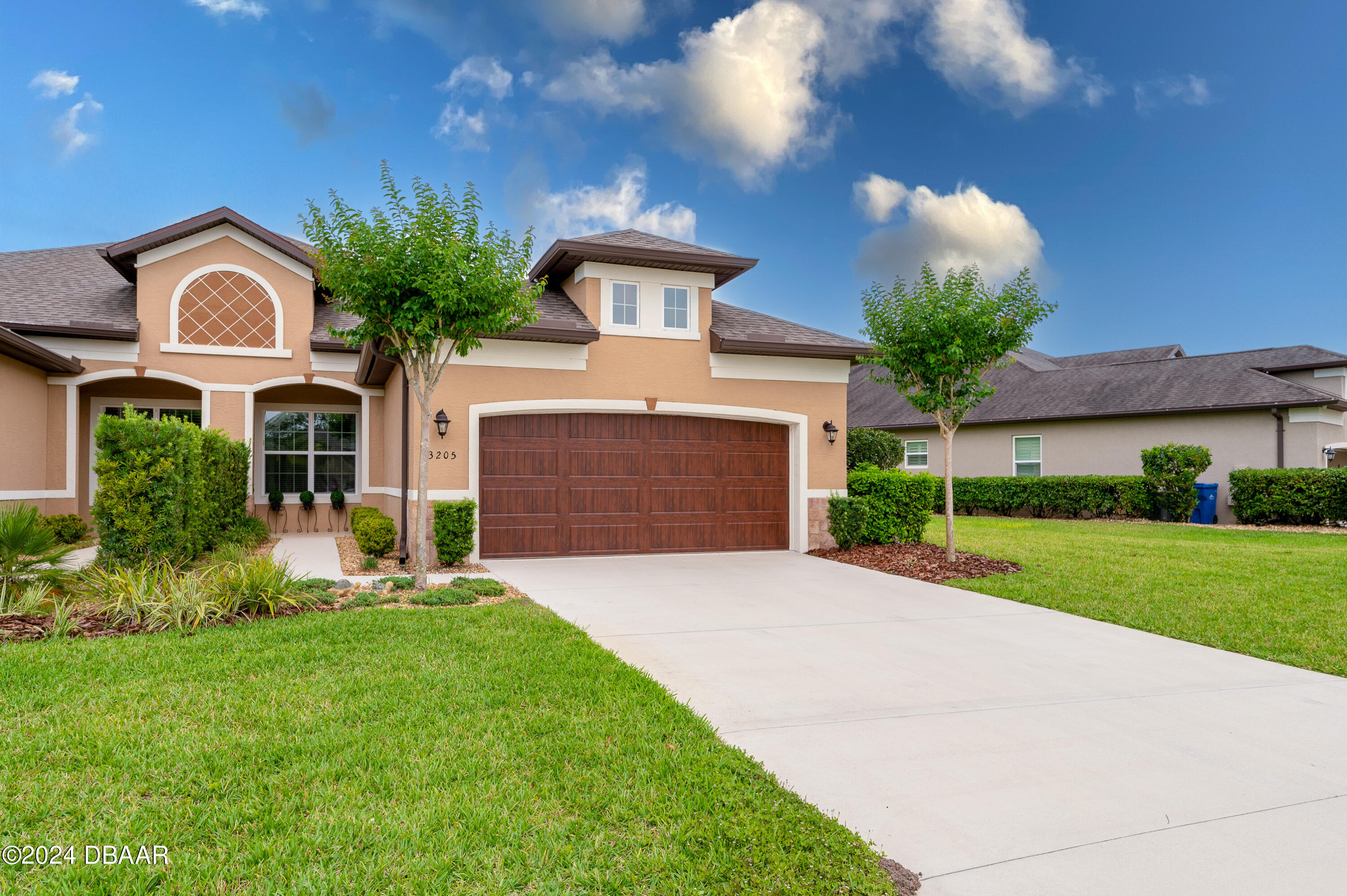 a front view of house with yard and green space