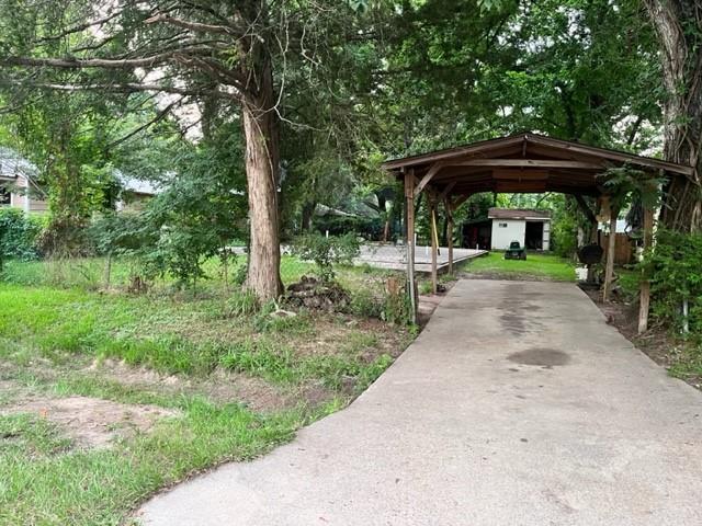 a view of backyard with table and chairs under an umbrella