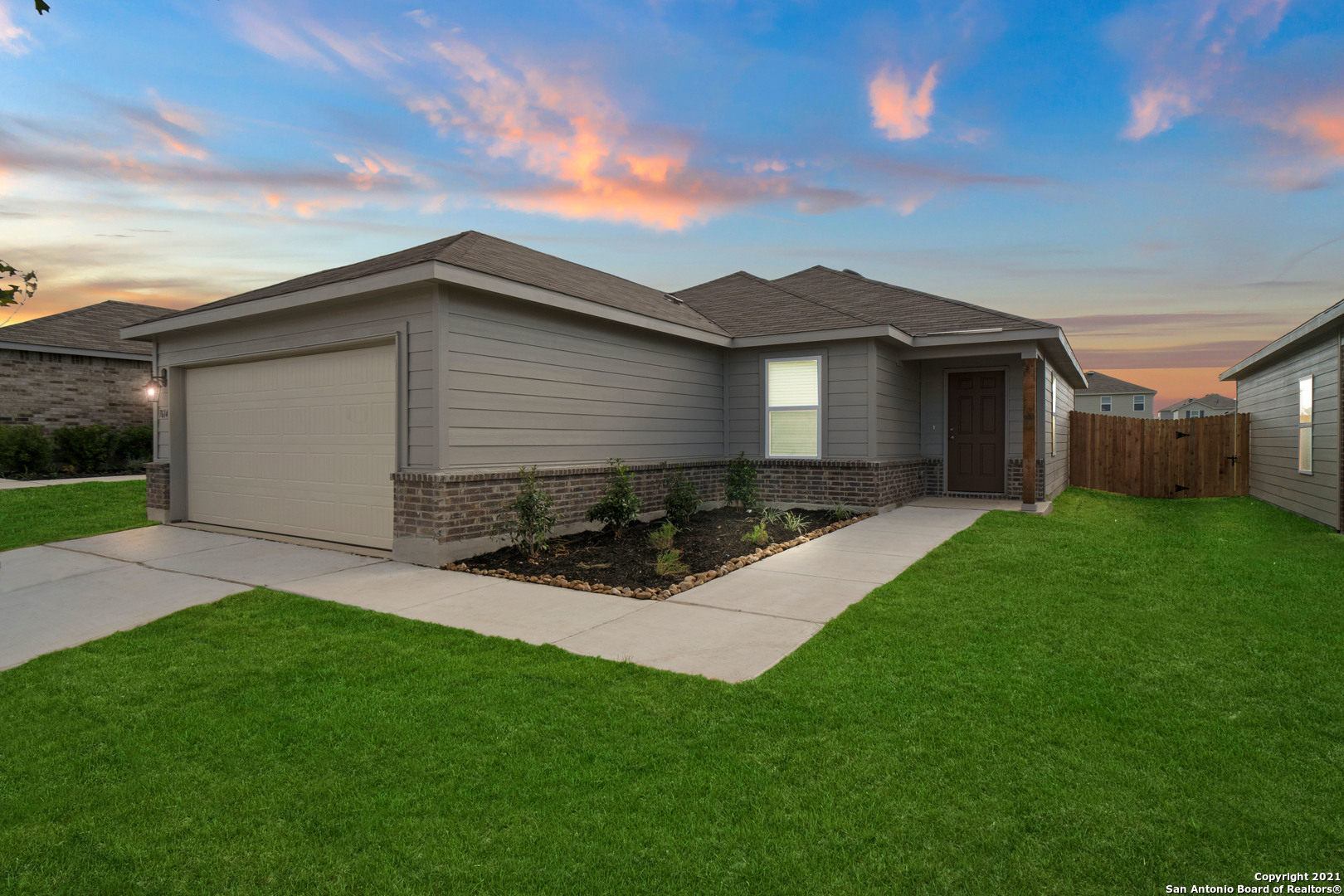 a front view of house with yard and green space