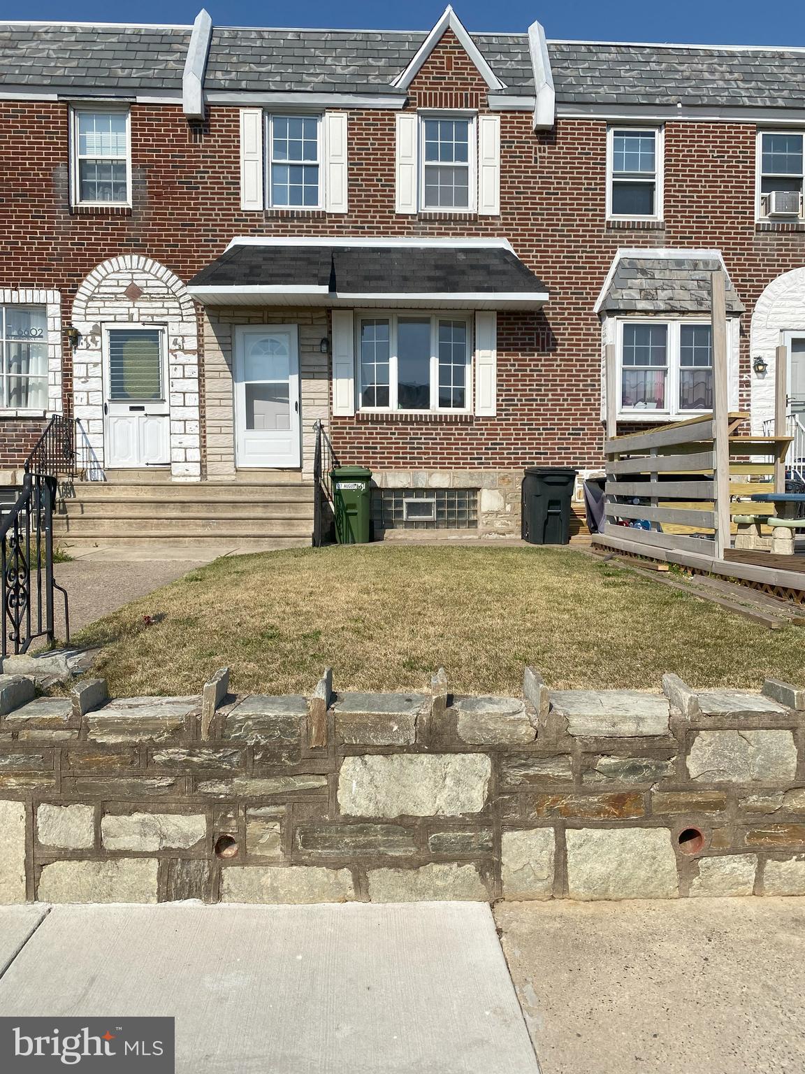 a view of a brick house with many windows