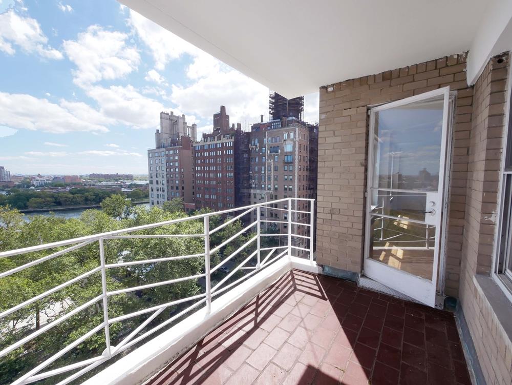 a view of a balcony with floor to ceiling windows with wooden floor