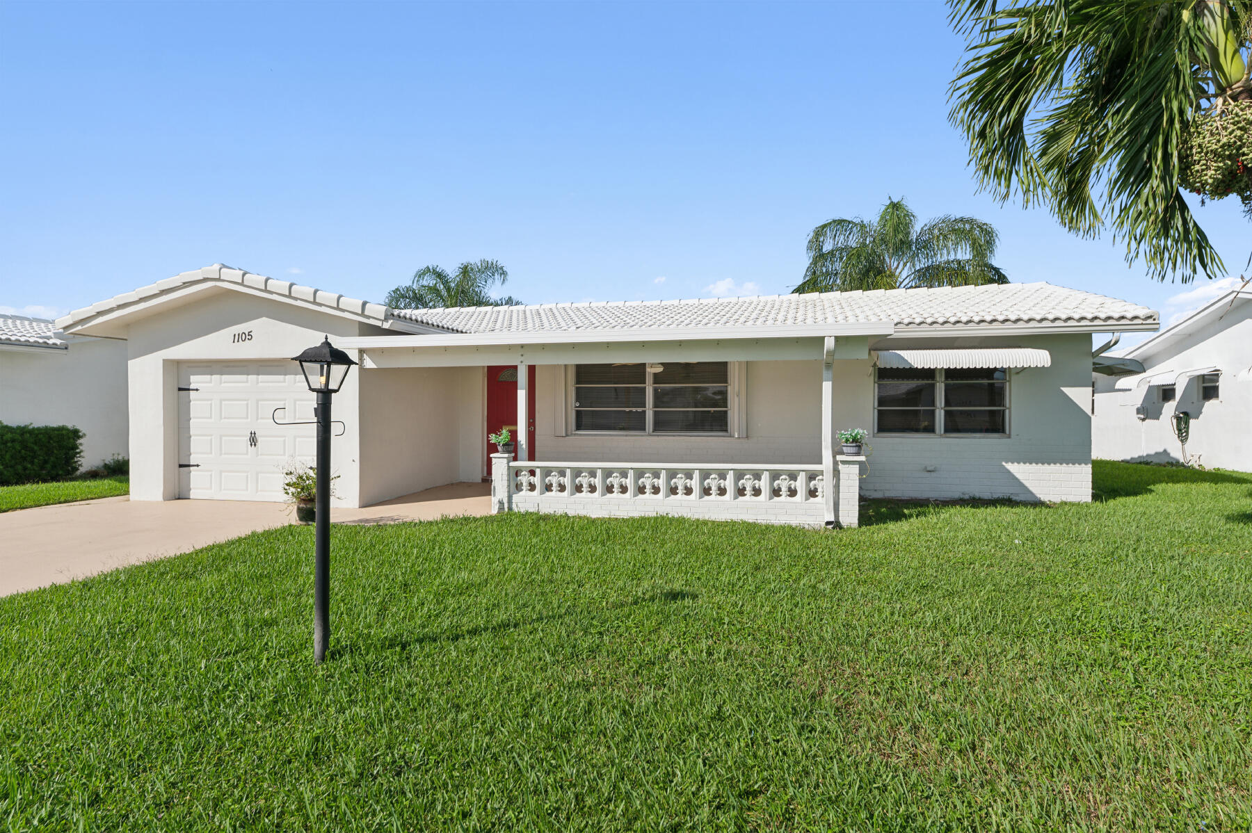 a front view of a house with a garden and yard